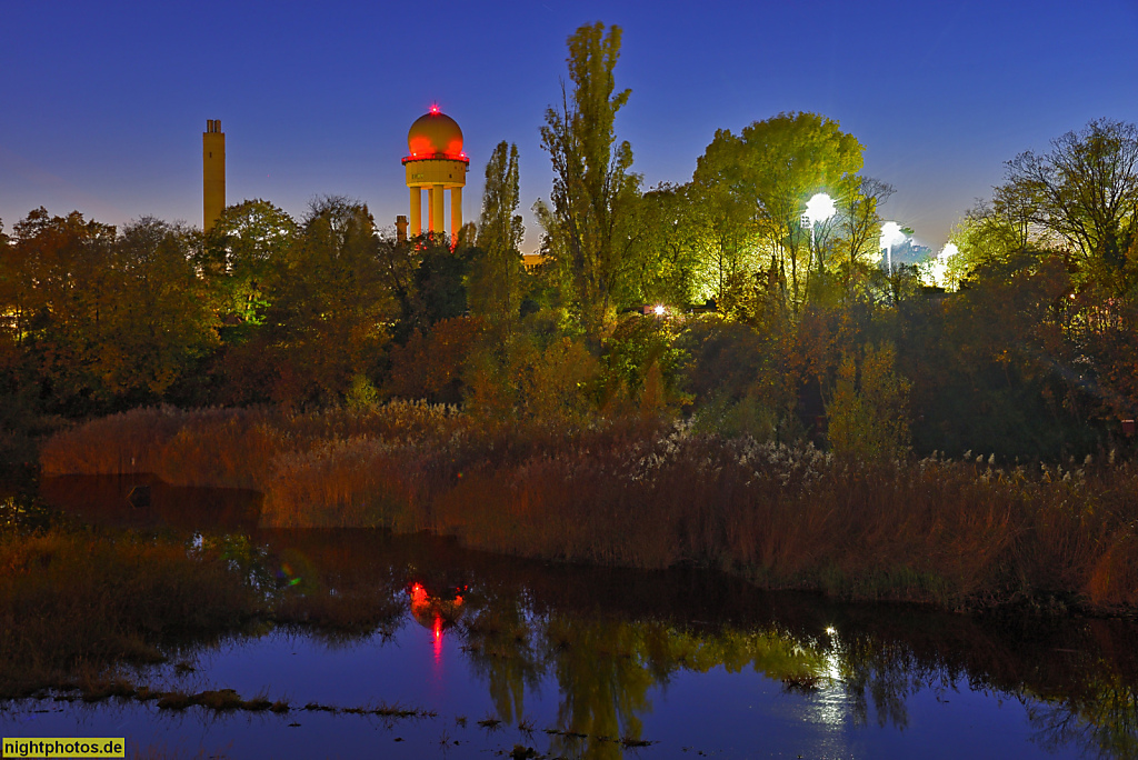 Berlin Kreuzberg. Regenwasser Rückhaltebecken Lilienthalstrasse 32 vor Radarturm des ehemaligen Flughafen Tempelhof. Flutlicht vom Fussballplatz Züllichauer Strasse